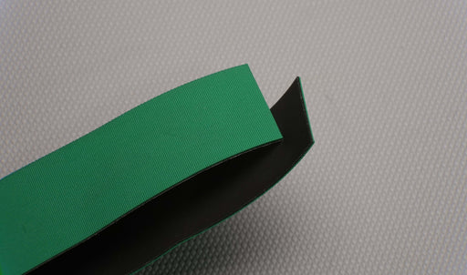 NC nylon conveyor belt showing green diamond surfacing top and black smooth bottom, 1.4mm thickness, both sides.