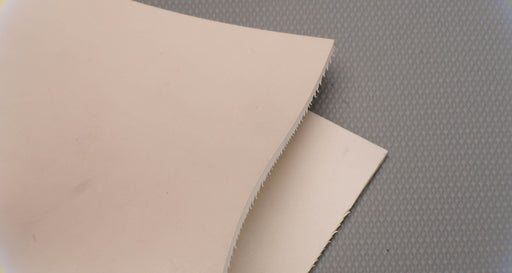 Top and bottom view of rubber conveyor belt with smooth white surfaces, 1/8 inch thickness, durometer 60, tensile strength of 700 psi, and elongation of 300%.