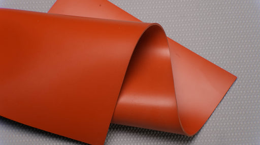 Top and bottom view of silicone rubber conveyor belt with smooth red surfaces, 1/16 inch thickness, tensile strength of 130-150 psi, and elongation of 200-280%.