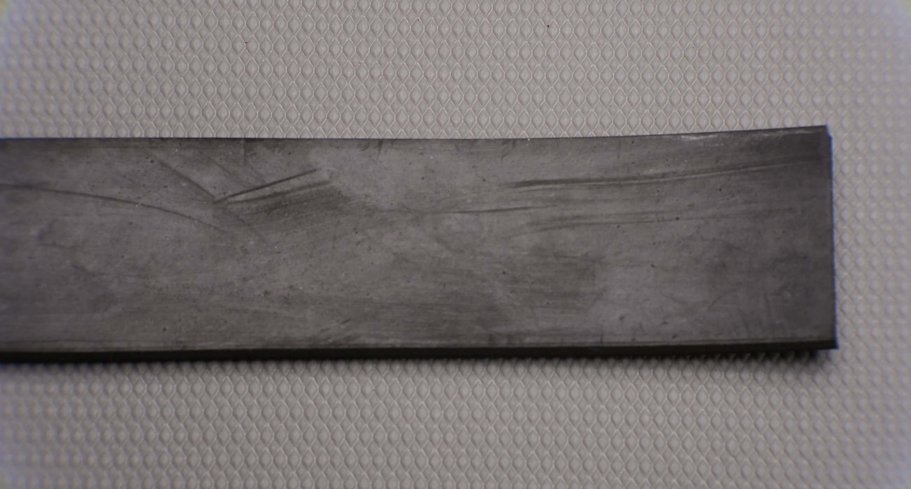 Back side of MOR rubber conveyor belt showing black rubber material. The belt is 1/4" thick with a durometer of 50, tensile strength of 1000 psi, elongation of 400%, and a temperature range of -20°F to +170°F.