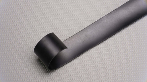 Photo showing the back side of a MOR rubber conveyor belt, featuring black rubber on both sides with a thickness of 1/32".