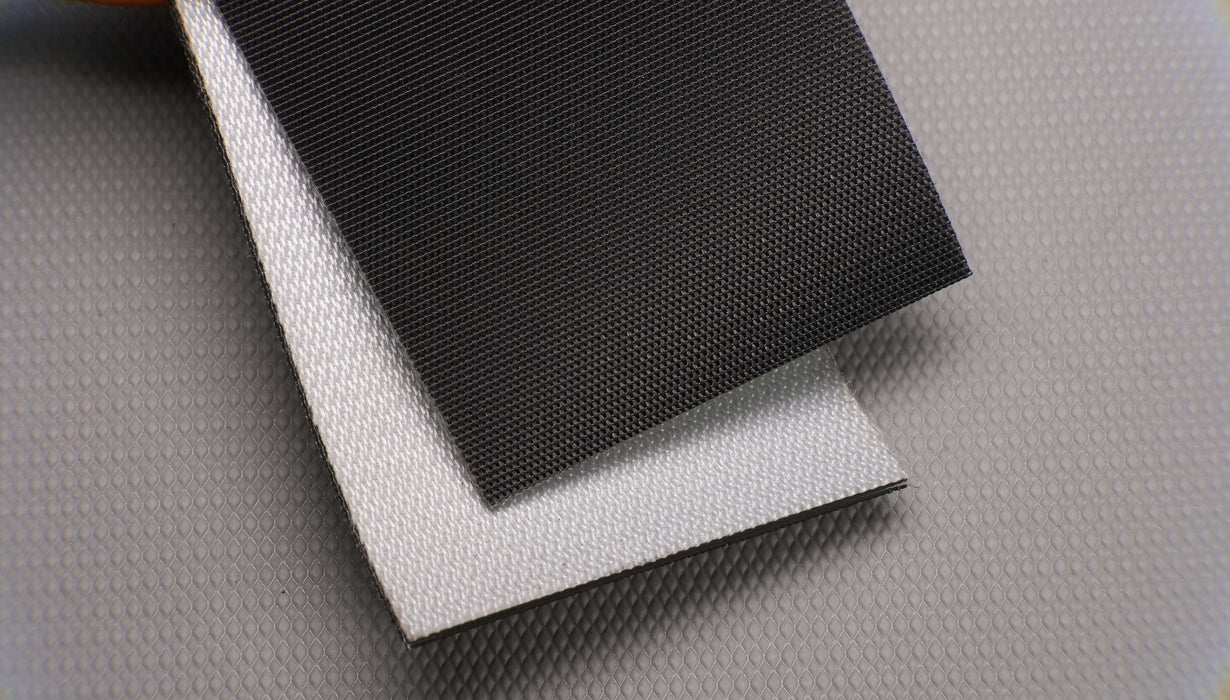 Front and back views of a PVC conveyor belt, 3mm thick. The belt has a black impregnated top and a white fabric bottom. Features three layers with monofilament fabric and a strength of 1% elongation at 15 nm.