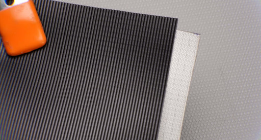Front and back side views of a conveyor belt made of PVC with monofilament fabric. The top has a longitudinal ribbed texture, while the bottom is fabric. The thickness is 3mm with black top color and white bottom color.