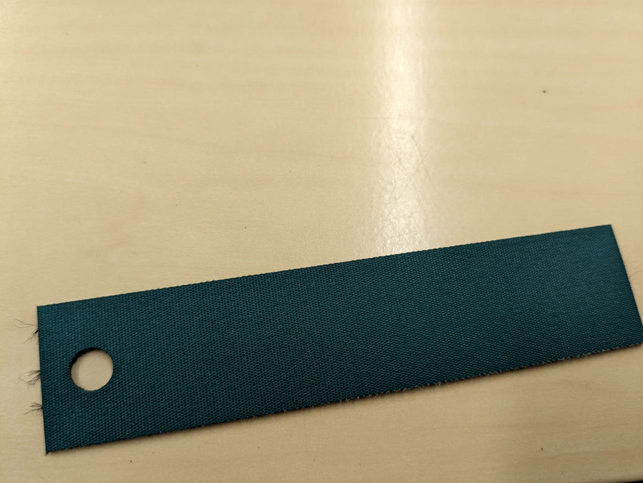 Top view of nylon conveyor belt materials showing green top fabric and black bottom fabric, 1.1mm thickness.