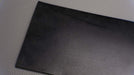 Front side view of MOR rubber conveyor belt with 1/8 inch thickness, black color, top and bottom rubber.






