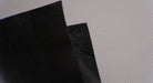 Alternate front and back side views of MOR rubber conveyor belt with 1/16 inch thickness, black color, top and bottom rubber.