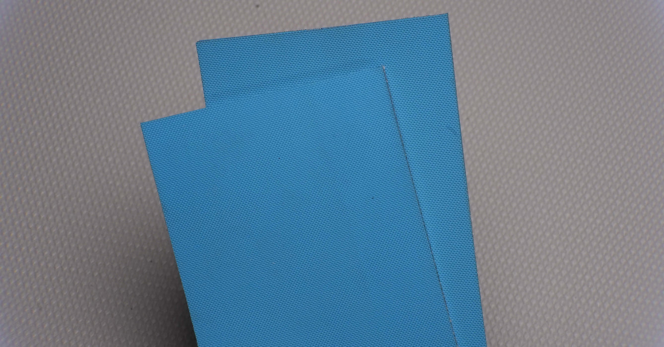 Front and back view of NC conveyor belt showing diamond surfacing in blue, made from nylon fabric with 4mm thickness.