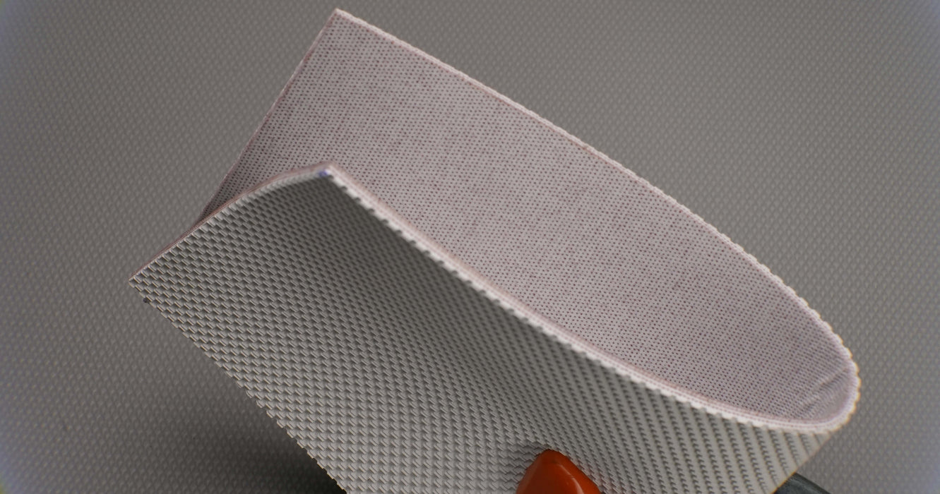 Side view of natural conveyor belt showing 0.25 inch thickness with white meat-cleat top and friction side bottom.






