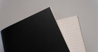 View showing both front and back sides of PVC conveyor belt with 2mm thickness, black smooth top color, and white fabric bottom color.