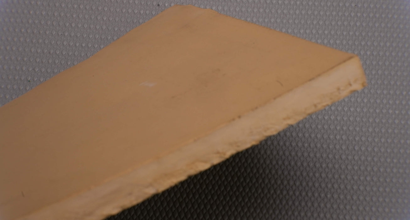 Side view showing the thickness of Puregum tan rubber conveyor belt with 1/2 inch thickness, tan color, 40 durometer, 3000 psi tensile strength, and 700% elongation.