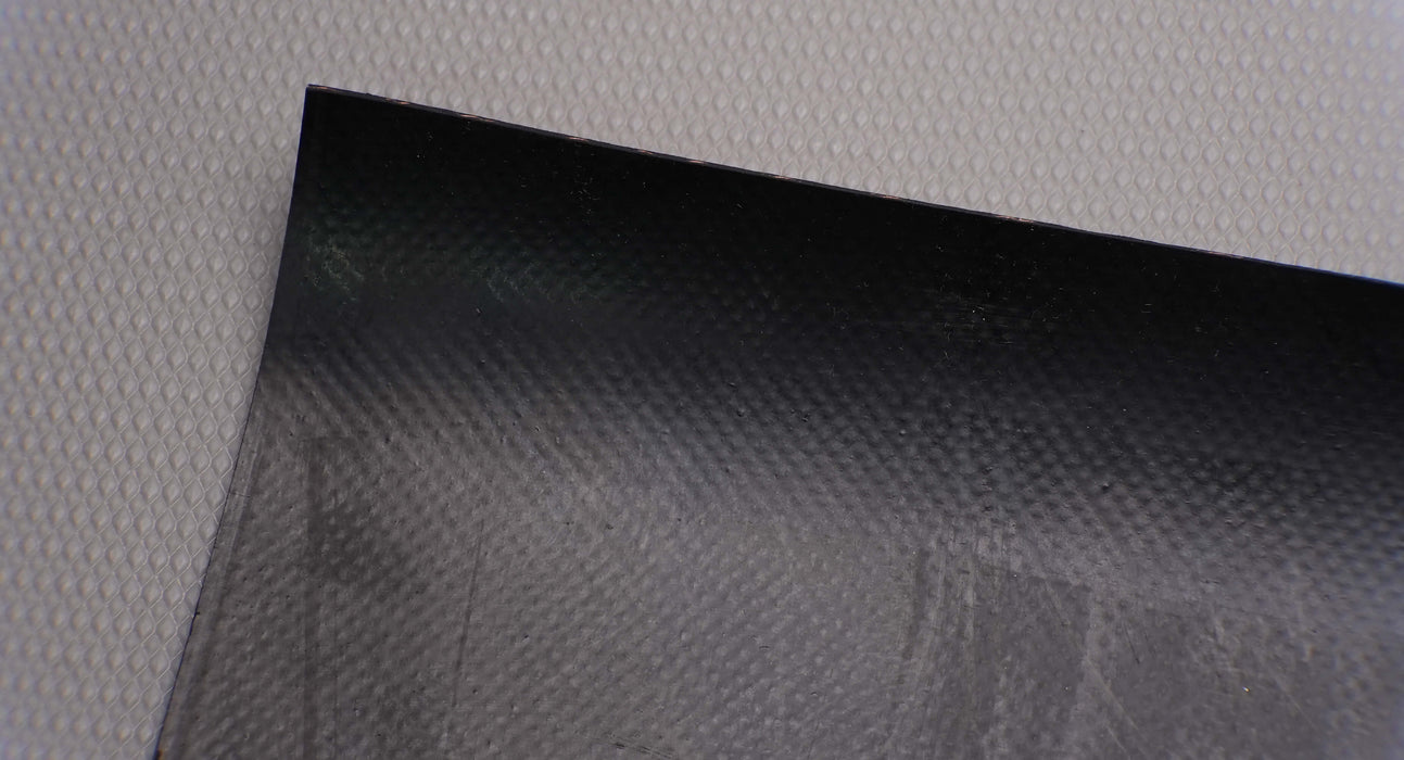 Bottom view of rubber conveyor belt with smooth black surface, 1/16 inch thickness, and temperature range of -10°F to +190°F.