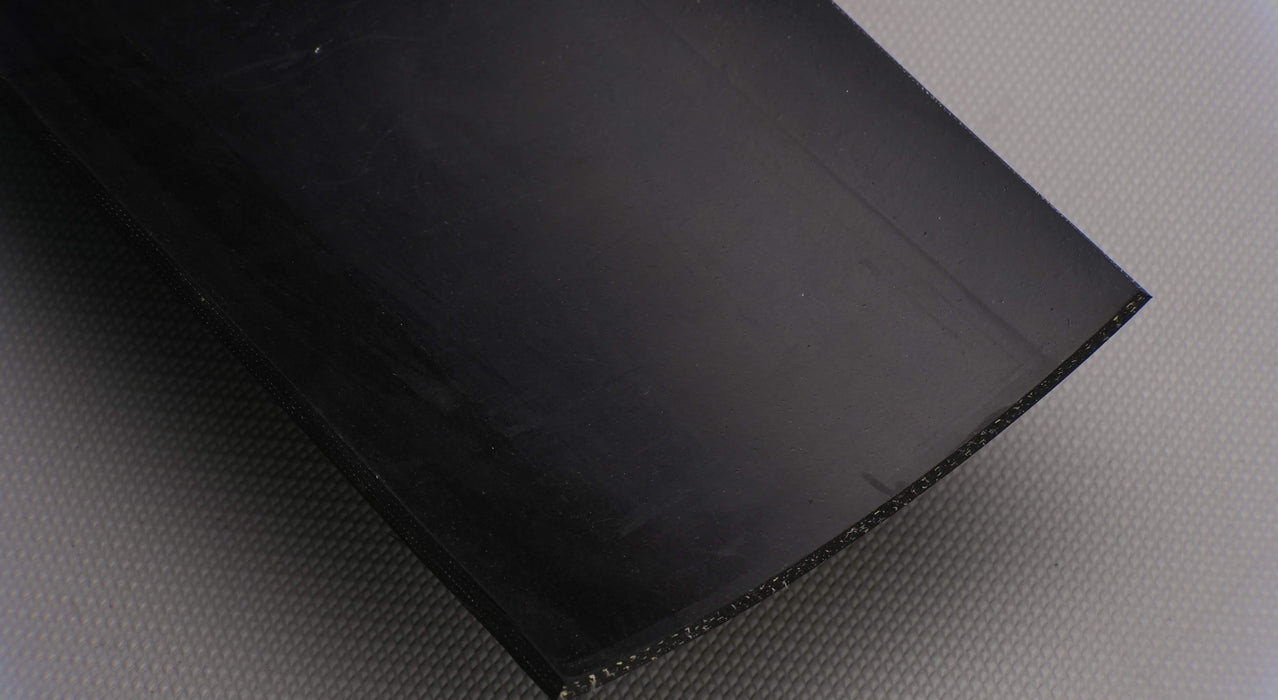 Bottom side view of rubber conveyor belt with smooth black surface, 1/4 inch thickness, and a temperature range of -10°F to +190°F.