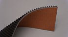 Side view of rubber conveyor belt showing thickness of 9/32 inch with black diamond top and brown bare bottom.







