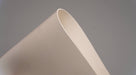 Top and bottom view of rubber conveyor belt with smooth white surfaces, 1/16 inch thickness, durometer 60, tensile strength of 700 psi, and elongation of 300%.