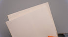  Top and bottom view of rubber conveyor belt showing 3/16 inch thickness, smooth white surfaces, and tensile strength of 700 psi.