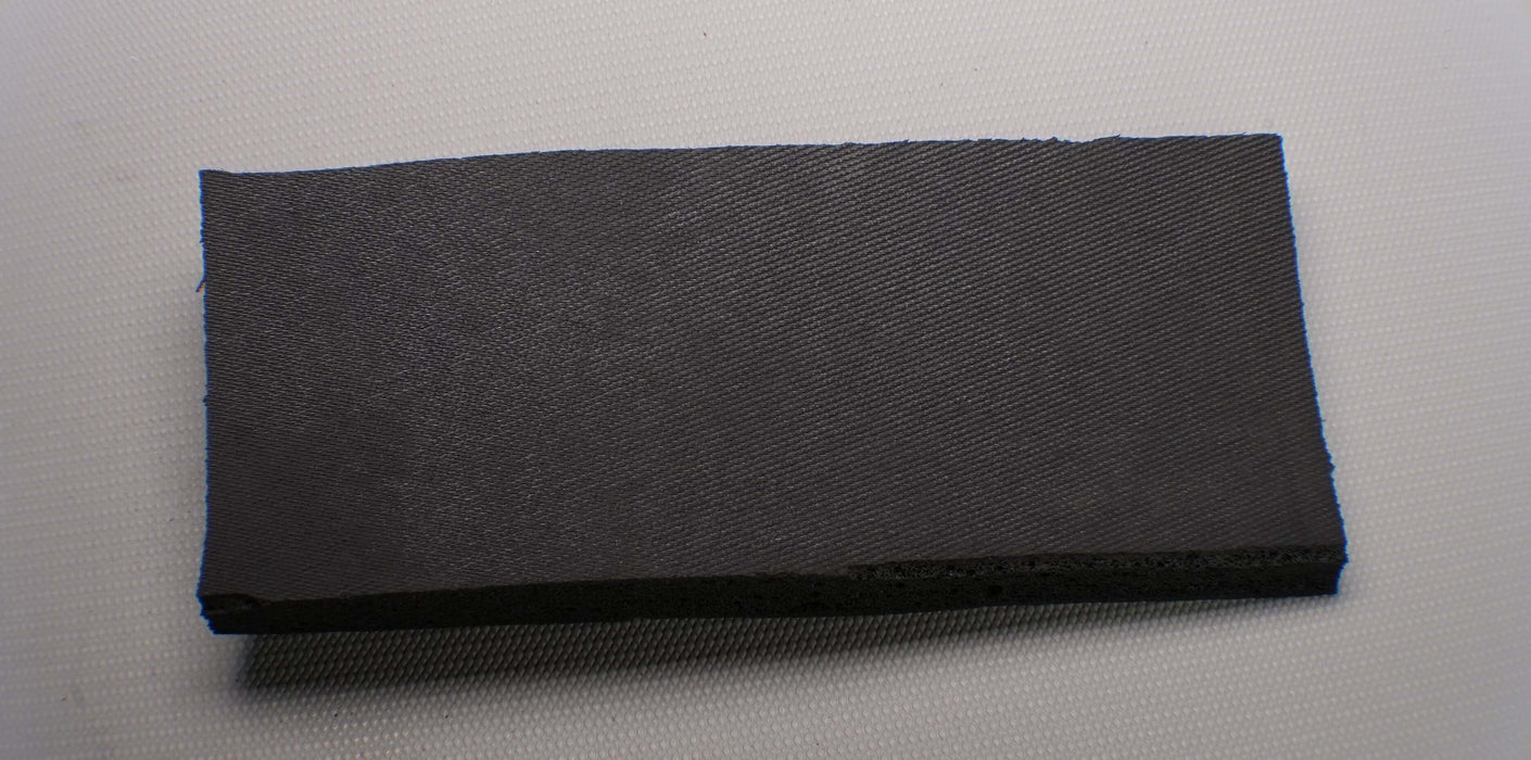 Front side view of a conveyor belt made from EPDM Rubber with open cell texture on both top and bottom. The belt is 1/4 inch thick with black color.