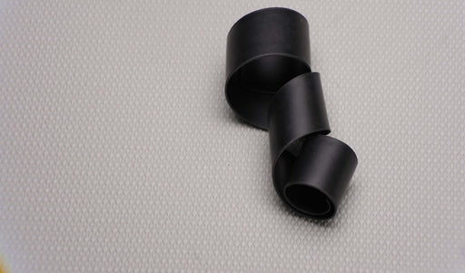 Flexible MOR rubber conveyor belt showing the front and back sides with black smooth surfaces, 1/32" thickness, highlighting both top and bottom materials and flexibility.