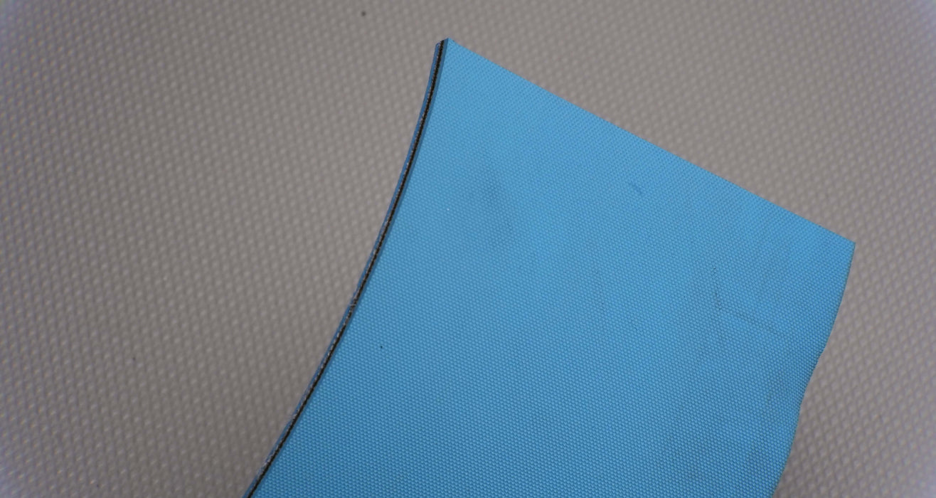 Back view of a nylon conveyor belt with diamond surfacing. The belt is 5mm thick, blue in color, with a single layer and a strength of 1% elongation at 3.8 nm.