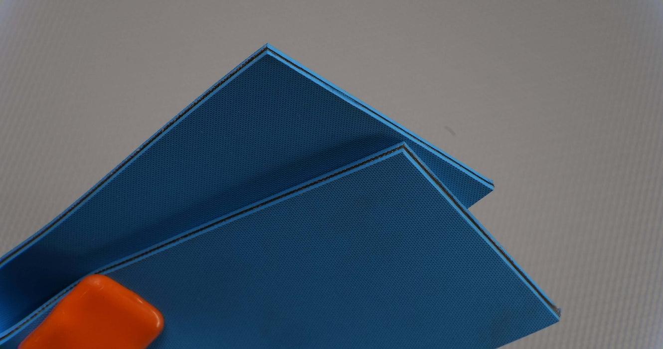 Bottom view of NC nylon conveyor belt with diamond surfacing, 4mm thickness, blue color, 1 layer, 1% elongation at 3.8 N/mm.
