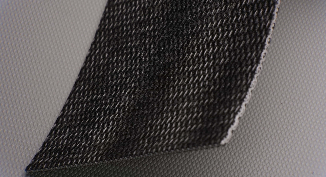 Front side of a PVC conveyor belt with 3.5mm thickness, featuring interwoven fabric on both the top and bottom sides, in black color, with a strength of 1% elongation at 28nm.