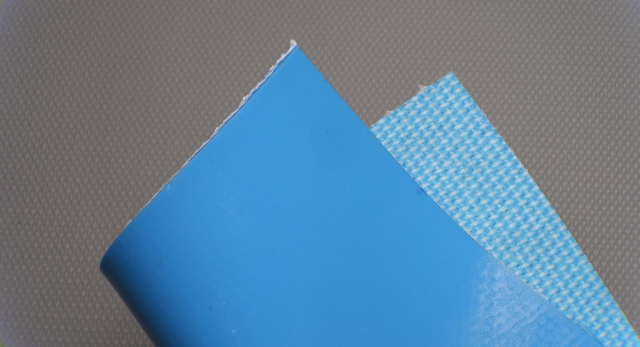 Photo showing both sides of a PVC conveyor belt with 4.5mm thickness, smooth blue top, and fabric blue bottom, with interwoven layers for strength of 1% elongation at 28nm.