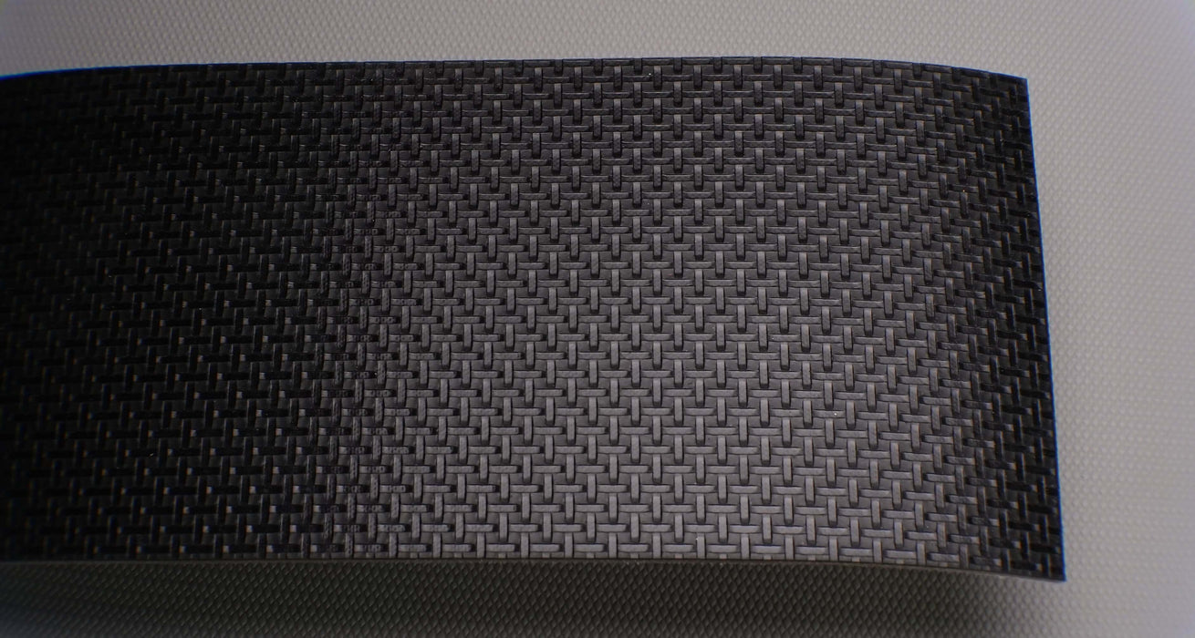 Front side of PVC conveyor belt with black basket weave top and white fabric bottom. The belt is 2mm thick, made of monofilament fabric, with a strength of 1% elongation at 8nm.






