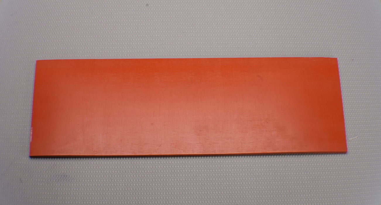 Top and front view of red silicone rubber conveyor belt with smooth surfaces, 1/16 inch thickness.
