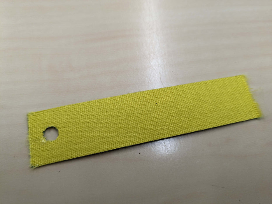 Bottom view of NC nylon conveyor belt on a sample, 0.8 nm thickness, yellow top and green bottom, fabric material, 1 layer, 1% elongation at 1.8 N/mm.
